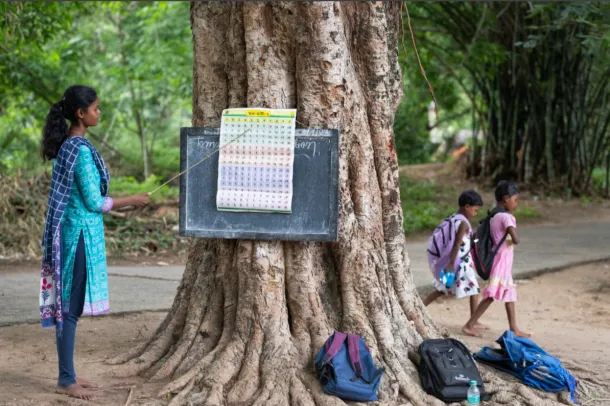 Teacher supporting schoolchildren in a learning environment